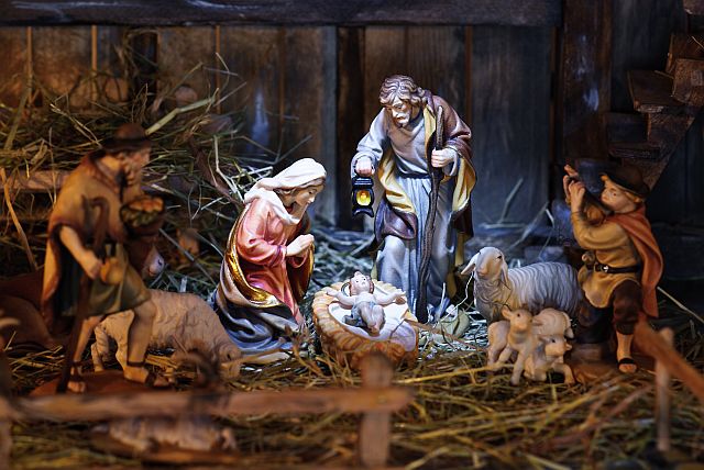 nativity scene with hand-colored figures made out of wood